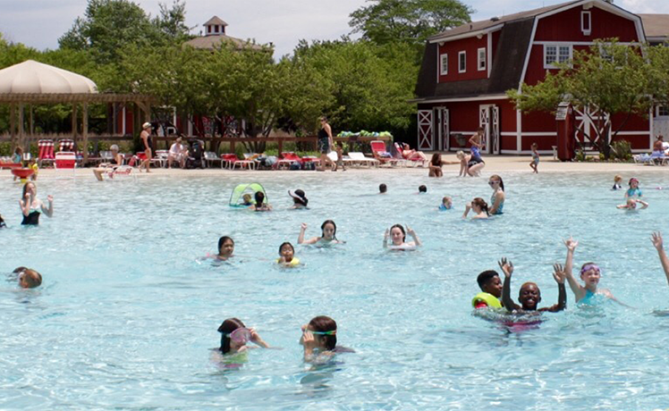 Large crowd of people swimming in pool at Splash Country Water Park